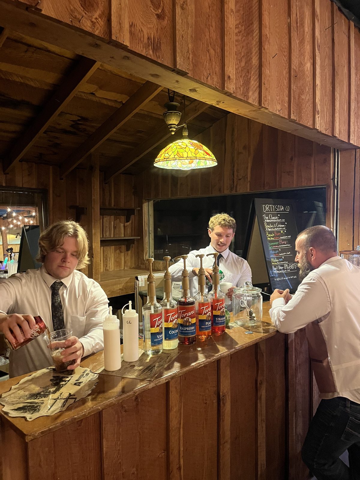 Full bar setup with the DRTY Soda menu board